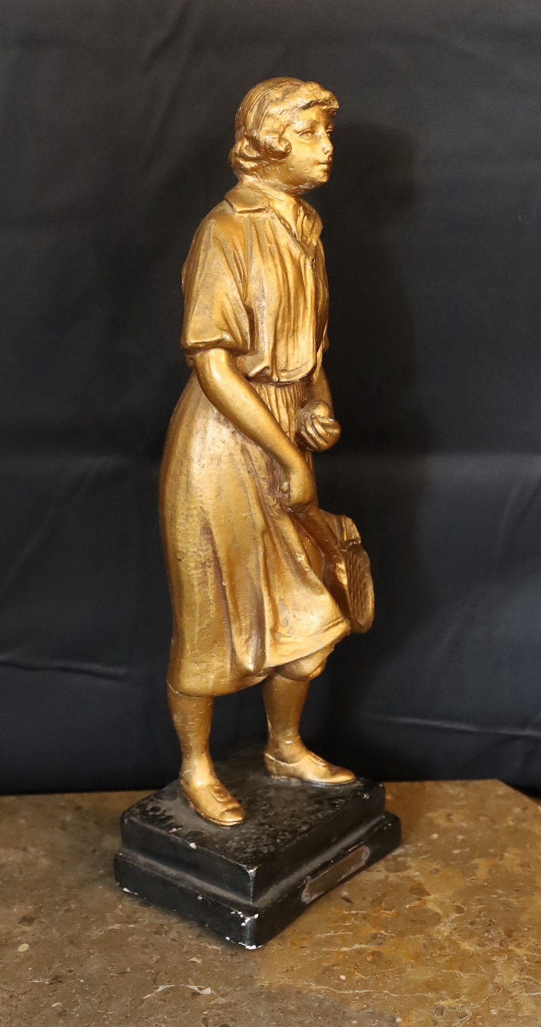 A 1930s French gilt plaster figure of a tennis player ‘Joueuse de Tennis’, height 42cm